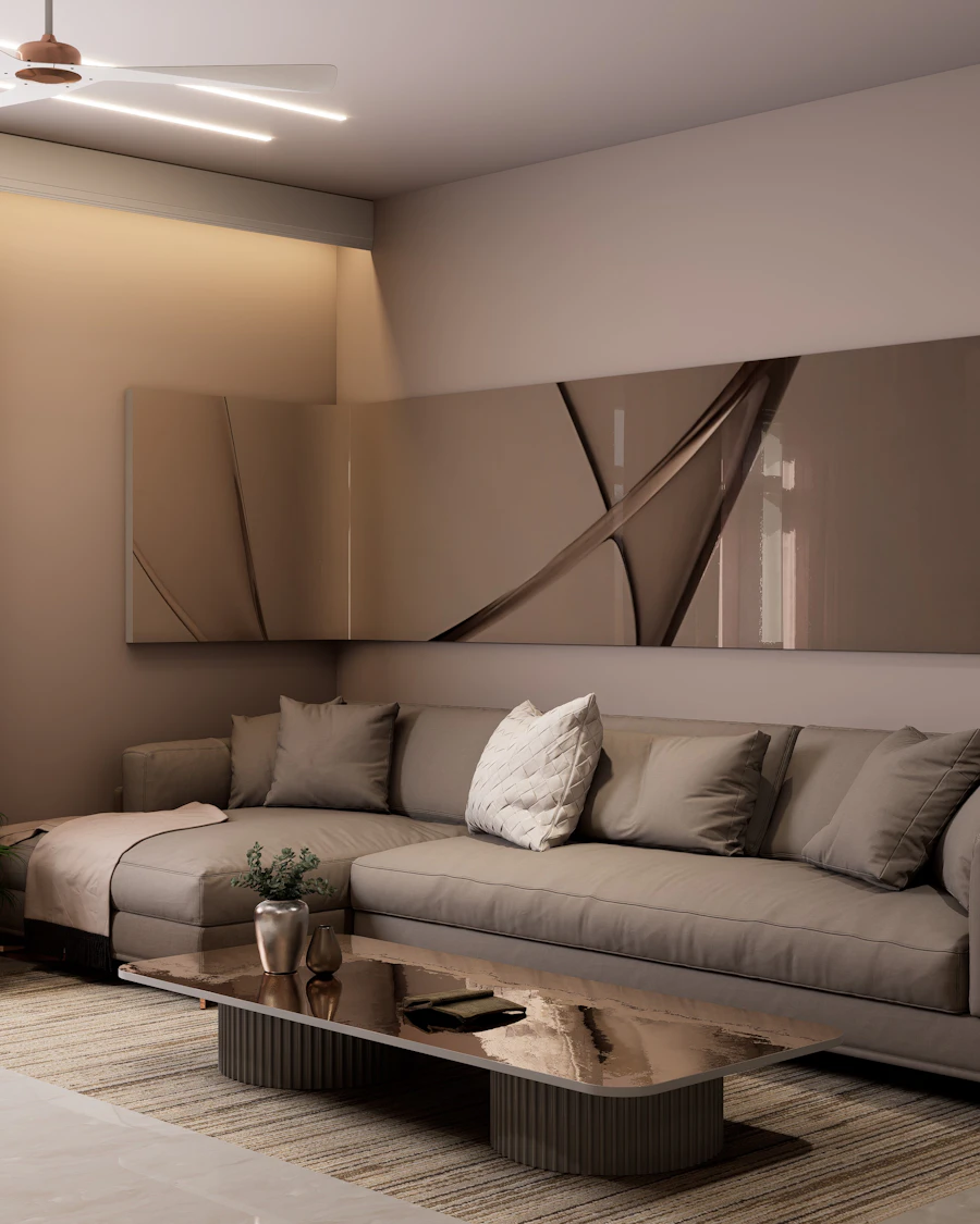 Living room with a long sectional sofa, a panelled feature wall and concealed cove lighting
